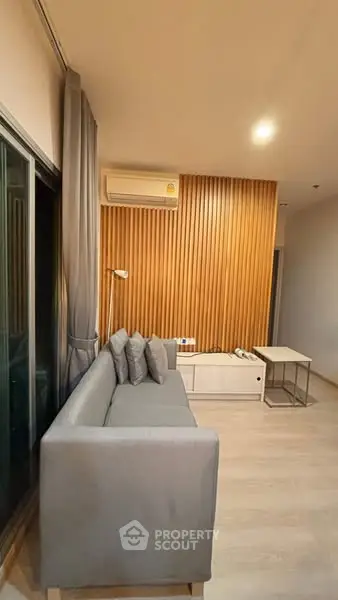 Modern living room with sleek design and cozy gray sofa