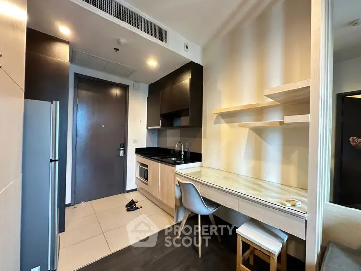 Modern kitchen with sleek cabinetry and integrated appliances in a stylish apartment.