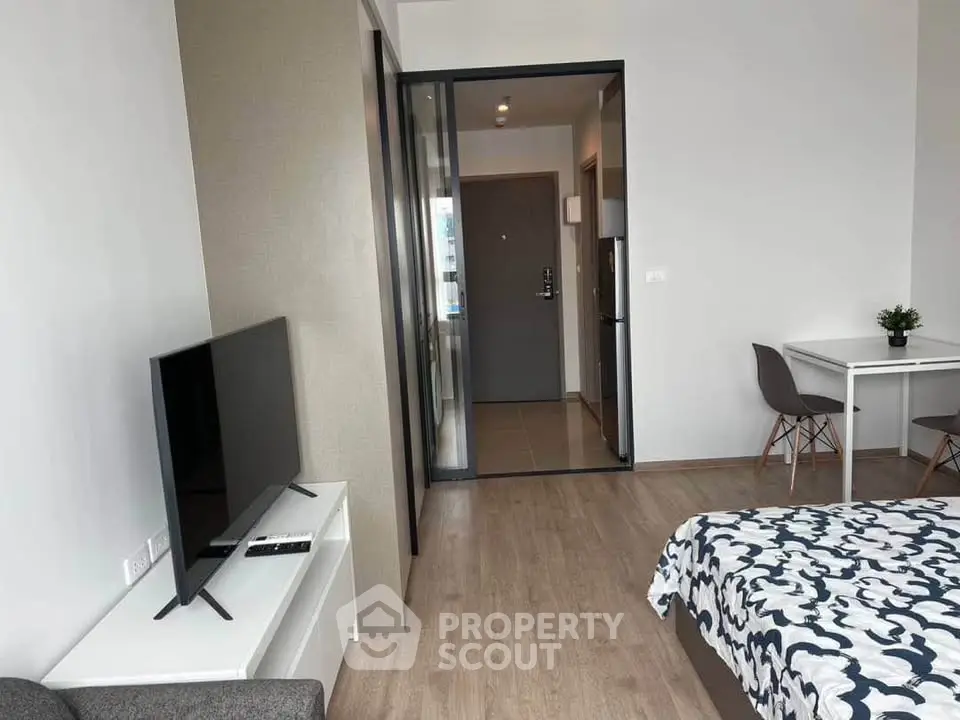 Modern studio apartment with open layout, featuring a cozy living area and stylish decor.