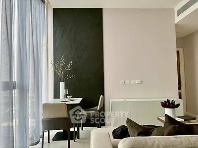 Modern living room with elegant dining area and floor-to-ceiling windows in a stylish apartment.