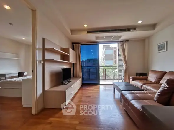 Spacious living room with modern furniture and balcony view in a stylish apartment.