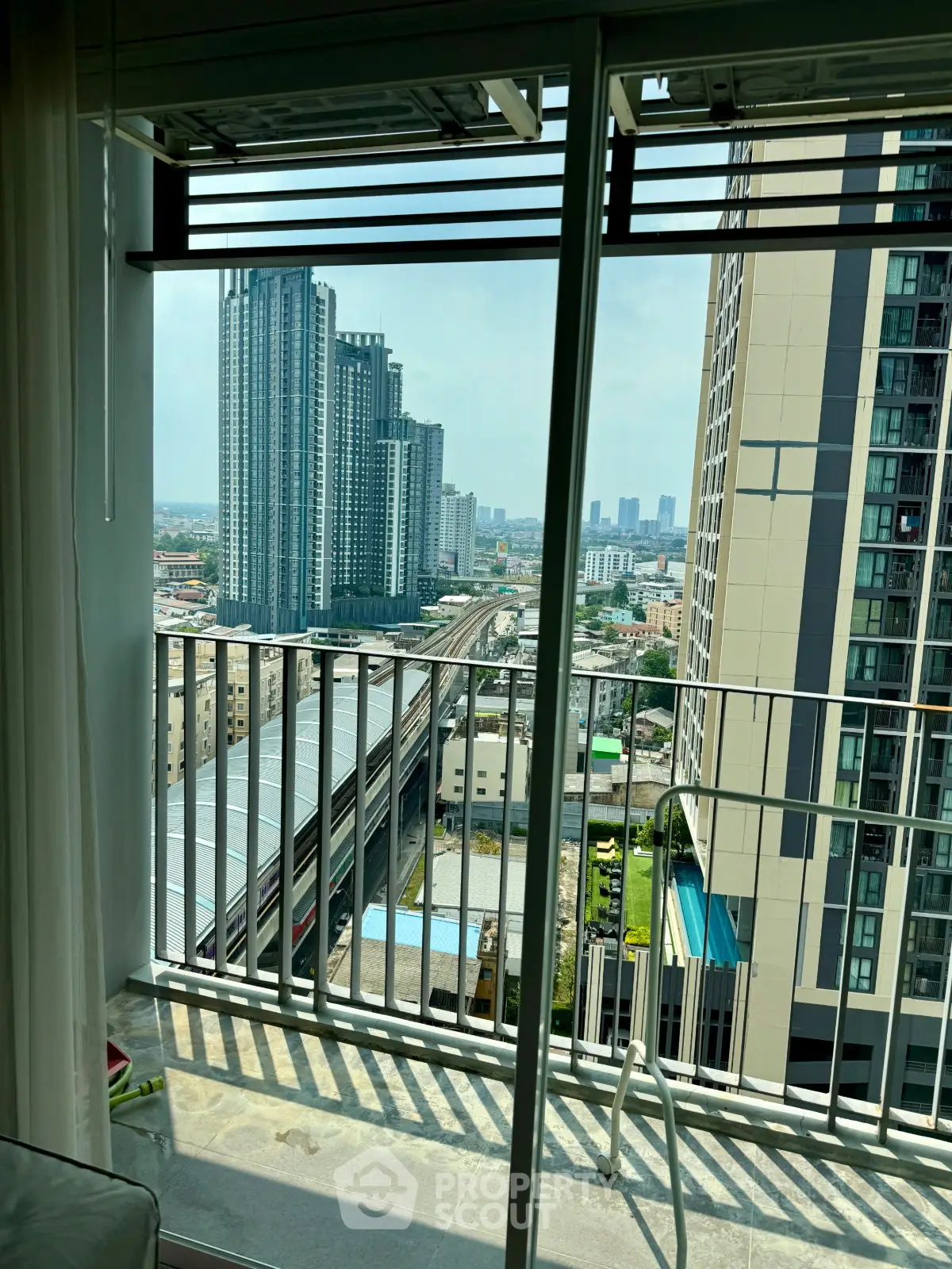 Stunning high-rise apartment view with expansive cityscape and modern balcony.