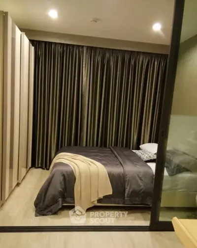 Cozy bedroom with elegant curtains and modern decor in a stylish apartment.
