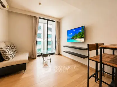Modern living room with sleek furniture and wall-mounted TV, featuring large windows and wooden flooring.