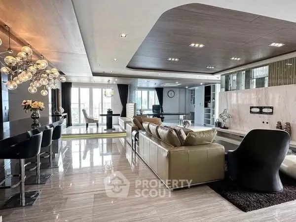 Luxurious open-plan living room with modern decor and elegant lighting.