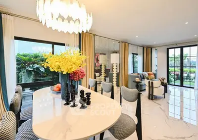 Luxurious open-plan living room with elegant dining area and garden view.