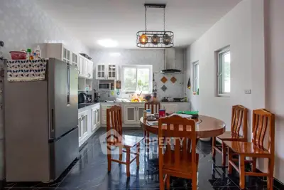 Spacious kitchen with modern appliances and elegant dining area, perfect for family gatherings.