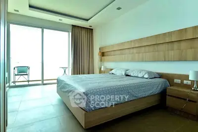 Spacious modern bedroom with large windows and balcony access