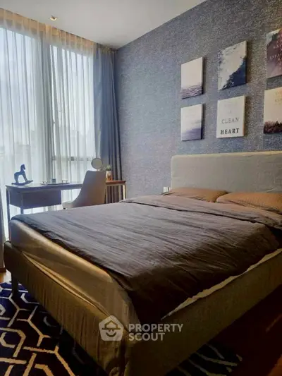 Modern bedroom with stylish decor and natural light