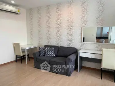 Modern living room with stylish sofa and elegant wallpaper, perfect for cozy relaxation.