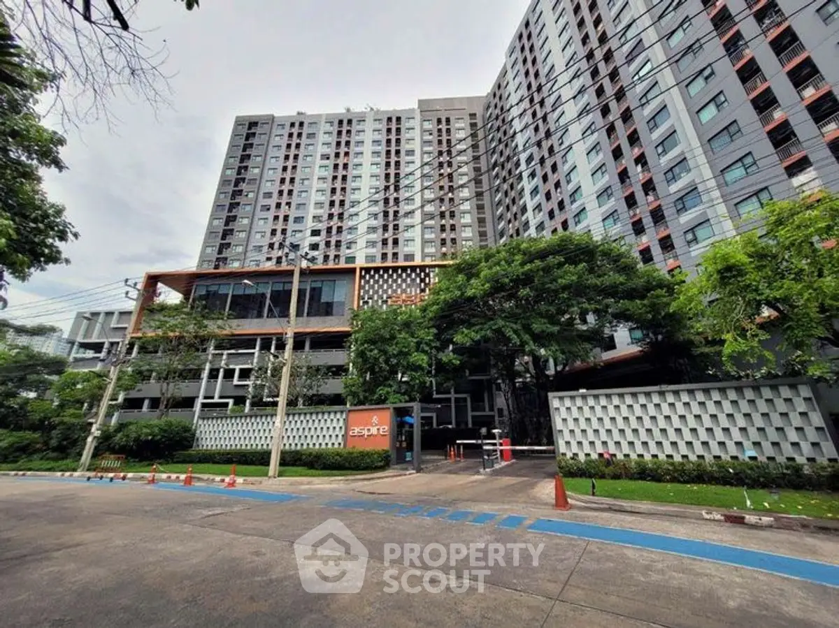Modern high-rise residential building with lush greenery and secure entrance