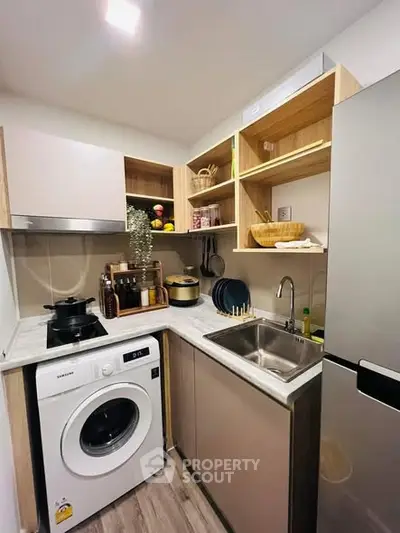 Modern compact kitchen with washing machine and sleek appliances