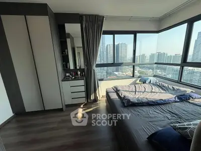 Modern bedroom with panoramic city view and sleek furnishings