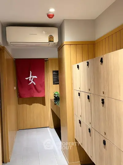 Modern interior with wooden lockers and air conditioning, ideal for storage or small office space.