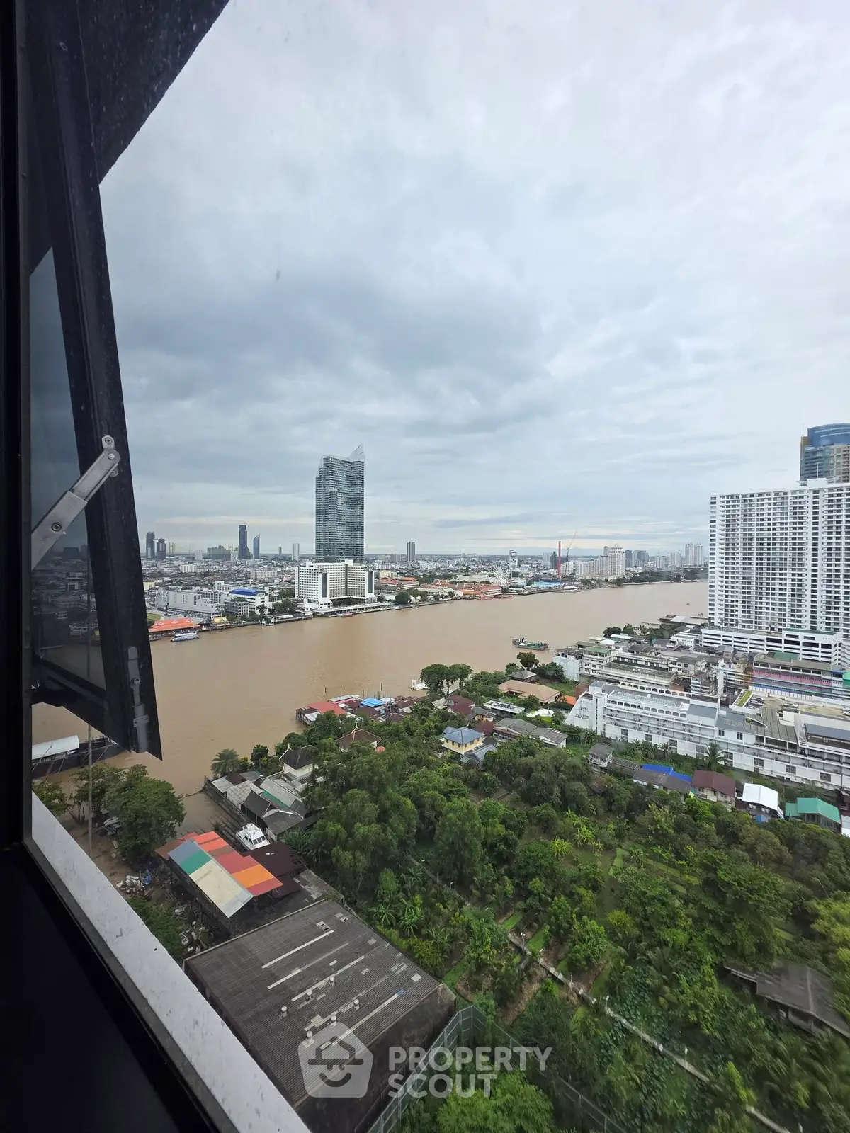 Stunning river view from high-rise building with cityscape in the background.