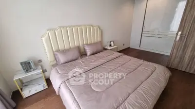 Elegant bedroom with plush bedding and modern decor in a stylish apartment.