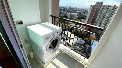 High-rise balcony with washing machine and stunning cityscape view