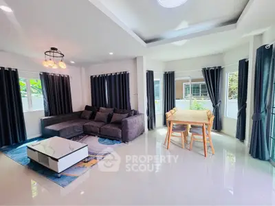 Spacious modern living room with large windows and elegant decor