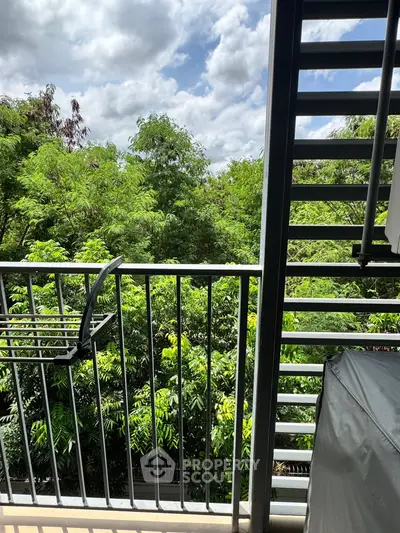Charming balcony view with lush greenery and clear skies