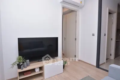 Modern living room with sleek TV setup and stylish decor in a contemporary apartment.