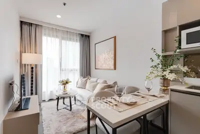 Modern living room with elegant decor and dining area in a cozy apartment.