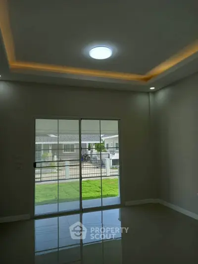 Spacious modern living room with sliding glass doors and recessed lighting