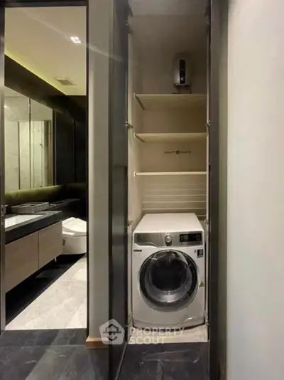 Modern bathroom with built-in washing machine and sleek storage shelves