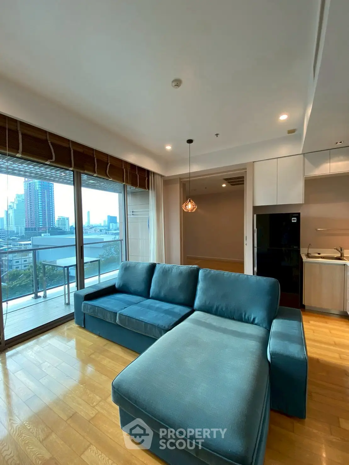 Spacious living room with modern sofa and city view balcony