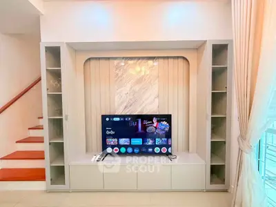 Modern living room with built-in TV unit and elegant shelving