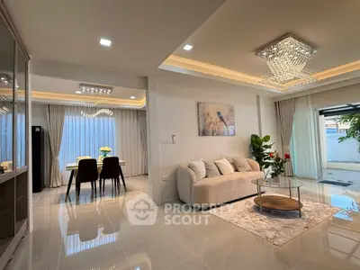 Luxurious open-plan living and dining area with elegant lighting and modern decor.