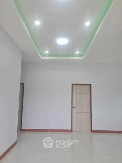 Spacious modern interior with elegant ceiling lights and sleek flooring.