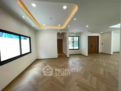 Spacious modern living room with elegant lighting and large windows
