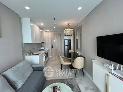 Modern open-layout living room with kitchen, dining area, and stylish decor