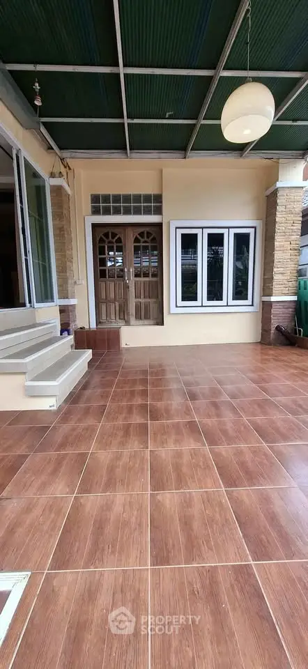 Spacious entrance with tiled flooring and elegant wooden doors