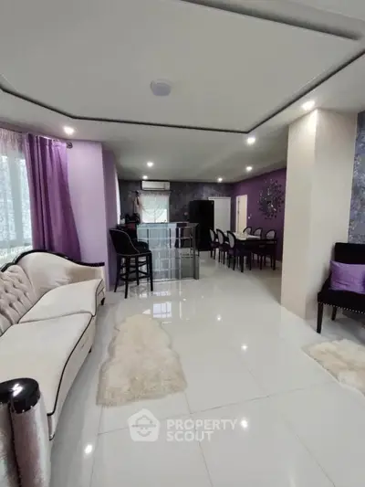 Elegant living room with modern decor and plush seating in a spacious open layout.