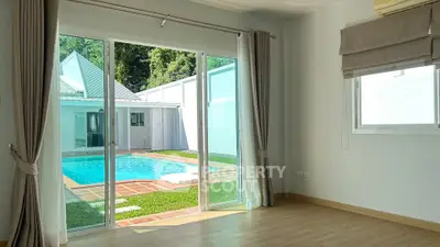 Spacious room with pool view and sliding glass doors in modern home