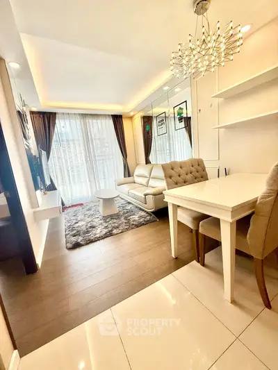 Modern living room with elegant decor and large windows in a stylish apartment.