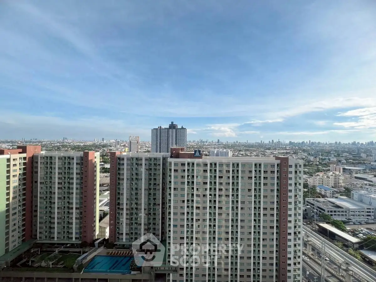 Stunning high-rise apartment buildings with panoramic city views and clear blue skies.