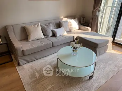 Modern living room with elegant sofa and glass coffee table near large window