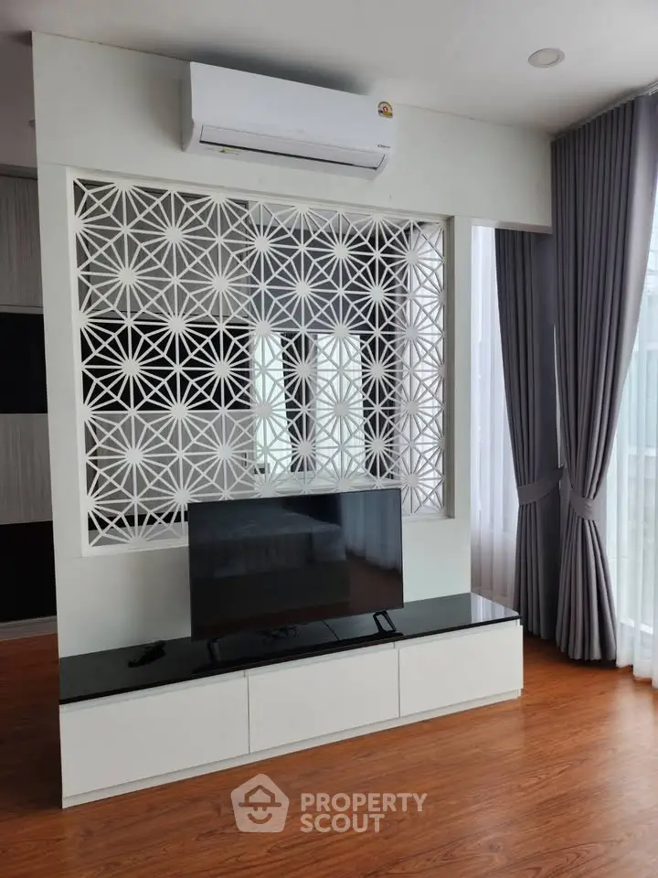 Modern living room with stylish partition and sleek TV setup