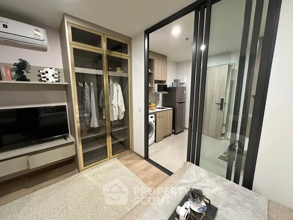 Modern apartment interior with open layout, featuring a cozy living area and sleek kitchen.