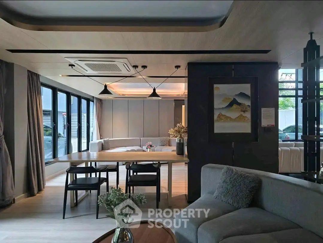 Modern living room with stylish decor and large windows for natural light.