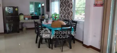 Spacious dining area with modern furniture and large windows for natural light.