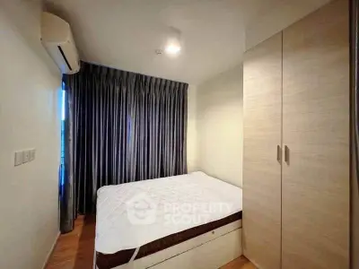 Cozy bedroom with modern air conditioning and ample closet space, perfect for comfortable living.