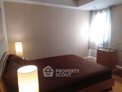 Cozy bedroom with soft lighting and modern furnishings, perfect for relaxation.