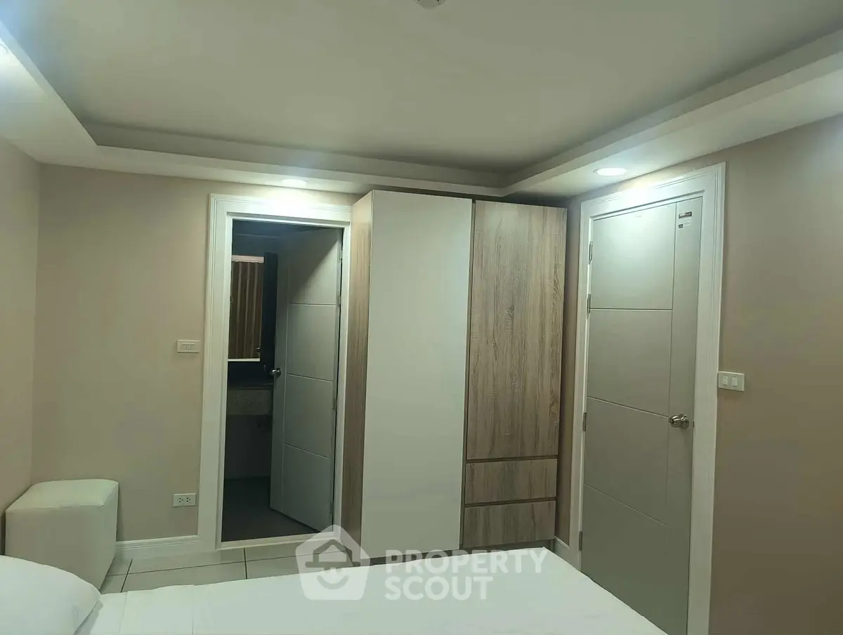 Modern bedroom with sleek wardrobe and bathroom access