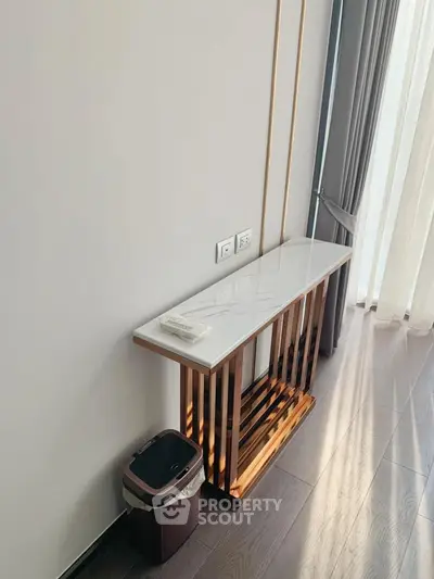 Elegant modern hallway with sleek console table and floor-to-ceiling curtains