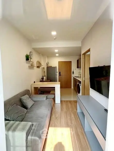 Modern living room with open kitchen layout and stylish decor