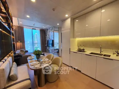 Luxurious open-plan living room and kitchen with modern decor and city view.