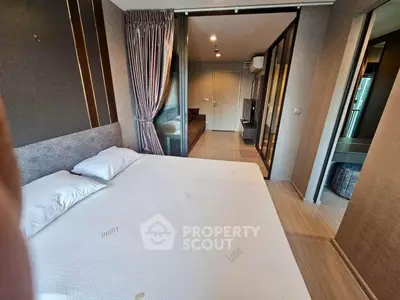 Modern bedroom with stylish decor and sliding glass doors in a contemporary apartment.